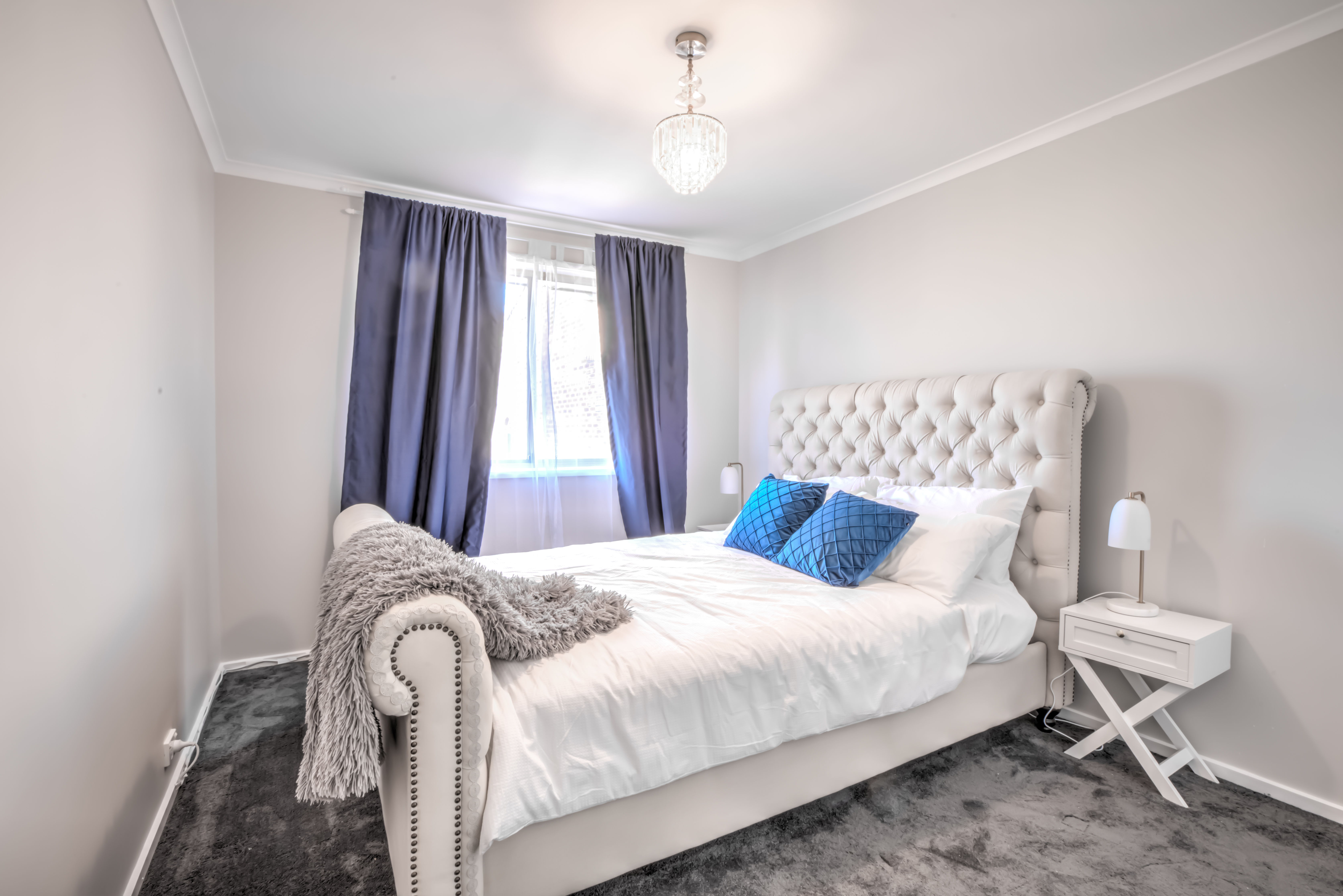 Second queen bedroom with tufted headboard at Bijoux Townhouse, North Canberra